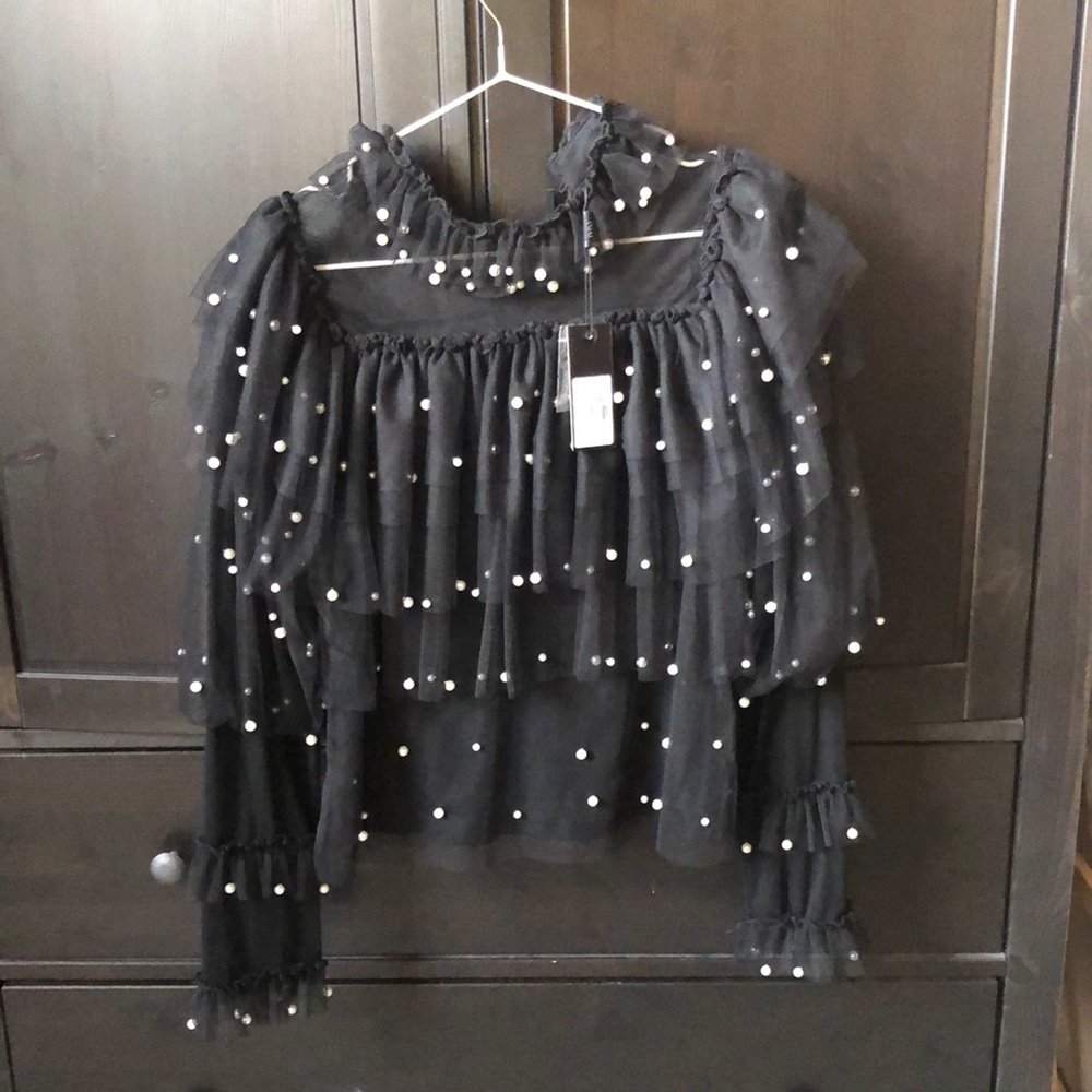 Tulle ruffle layered top with pearls.